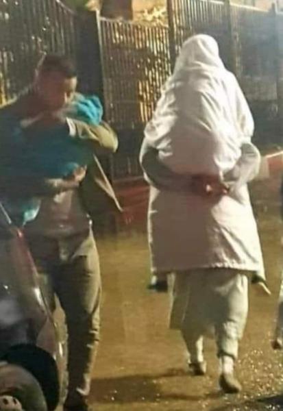 شاهد -صورة من امام مستشفي الاب يحمل ابنة والابن يحمل امة